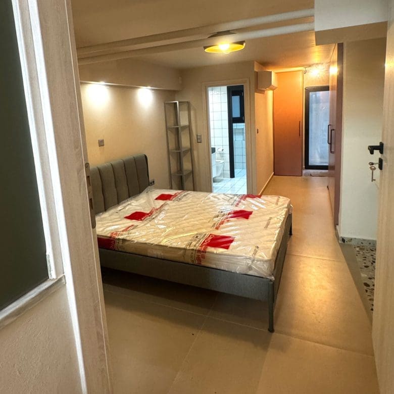 Bedroom area with double bed and hallway view in a compact apartment, Pangrati, Athens, Greece
