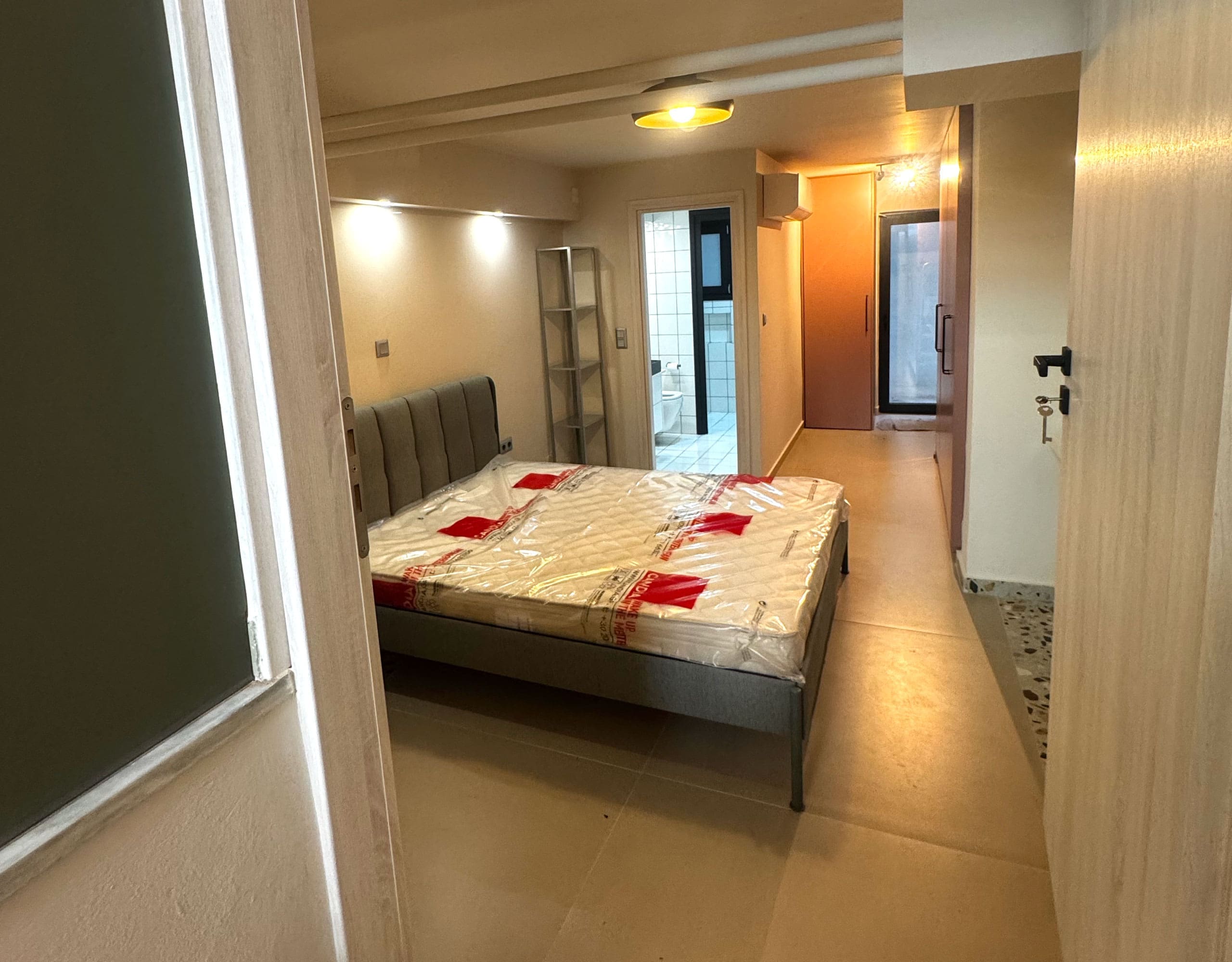 Pangrati Investment Apartment 51 sqm – Bedroom Area And Hallway Bedroom area with double bed and hallway view in a compact apartment, Pangrati, Athens, Greece