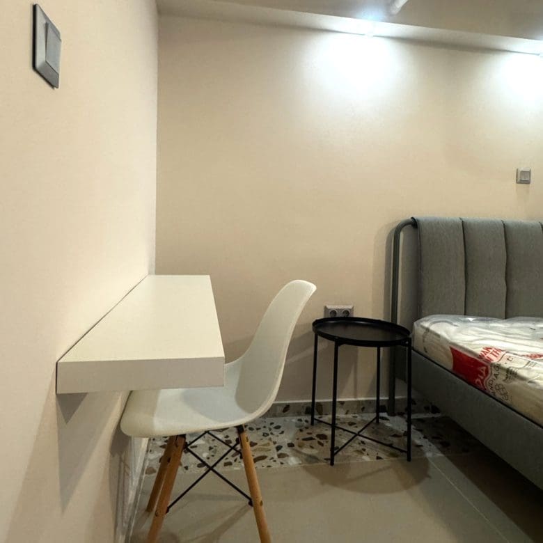 Bedroom area with double bed and compact desk setup, Pangrati, Athens, Greece