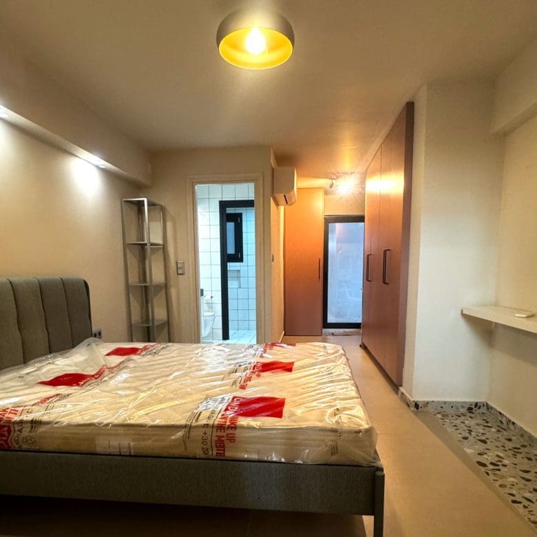 Bedroom with double bed, wall-mounted TV, and compact workspace, Pangrati, Athens, Greece