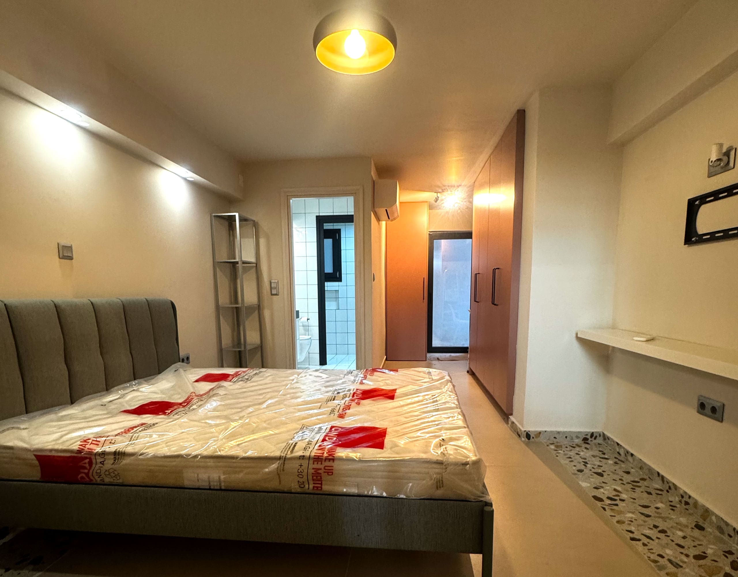 Pangrati Investment Apartment 51 sqm – Bedroom With Workspace Bedroom with double bed, wall-mounted TV, and compact workspace, Pangrati, Athens, Greece