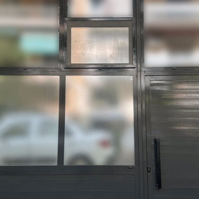 Large window with frosted glass panels and black frame, Pangrati, Athens, Greece