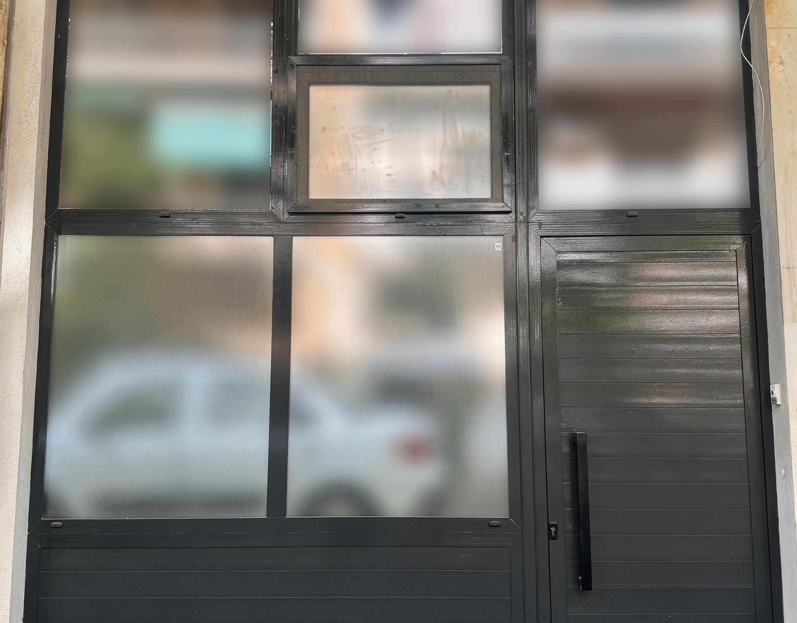 Pangrati Investment Apartment 51 sqm – Frosted Window Detail Large window with frosted glass panels and black frame, Pangrati, Athens, Greece