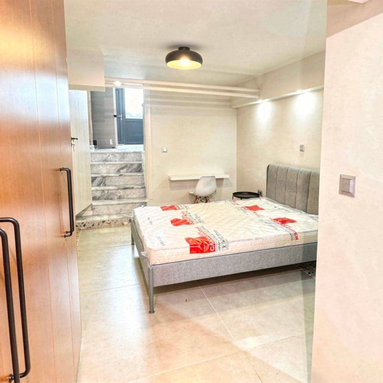Bedroom with double bed and bright interior finishes, Pangrati, Athens, Greece