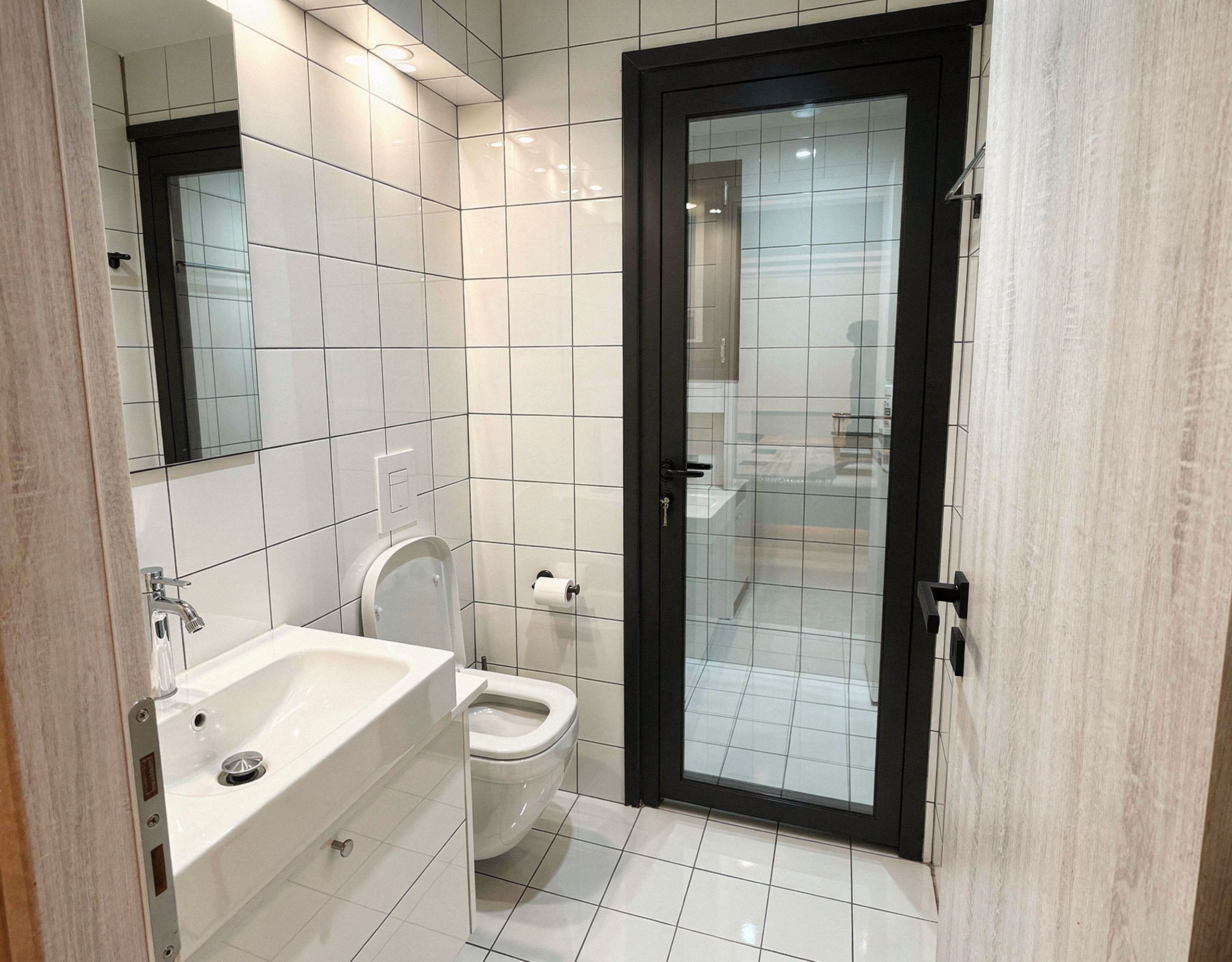 Pangrati Investment Apartment 51 sqm – Bathroom With Shower Bathroom with white tiles, vanity, and glass shower door, Pangrati, Athens, Greece