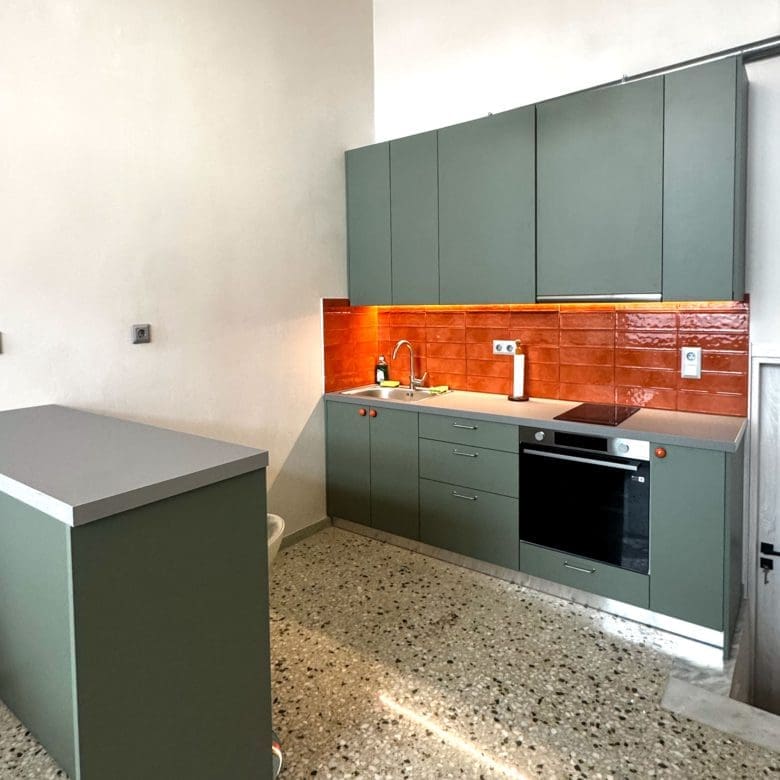 Modern kitchen with green cabinetry, peninsula counter, and orange tile backsplash, Pangrati, Athens, Greece