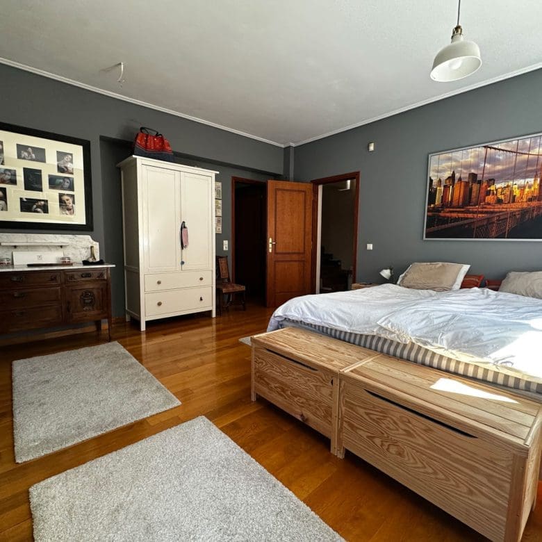 Bedroom with double bed, grey walls, and wood flooring, Thrakomakedones, Athens, Greece