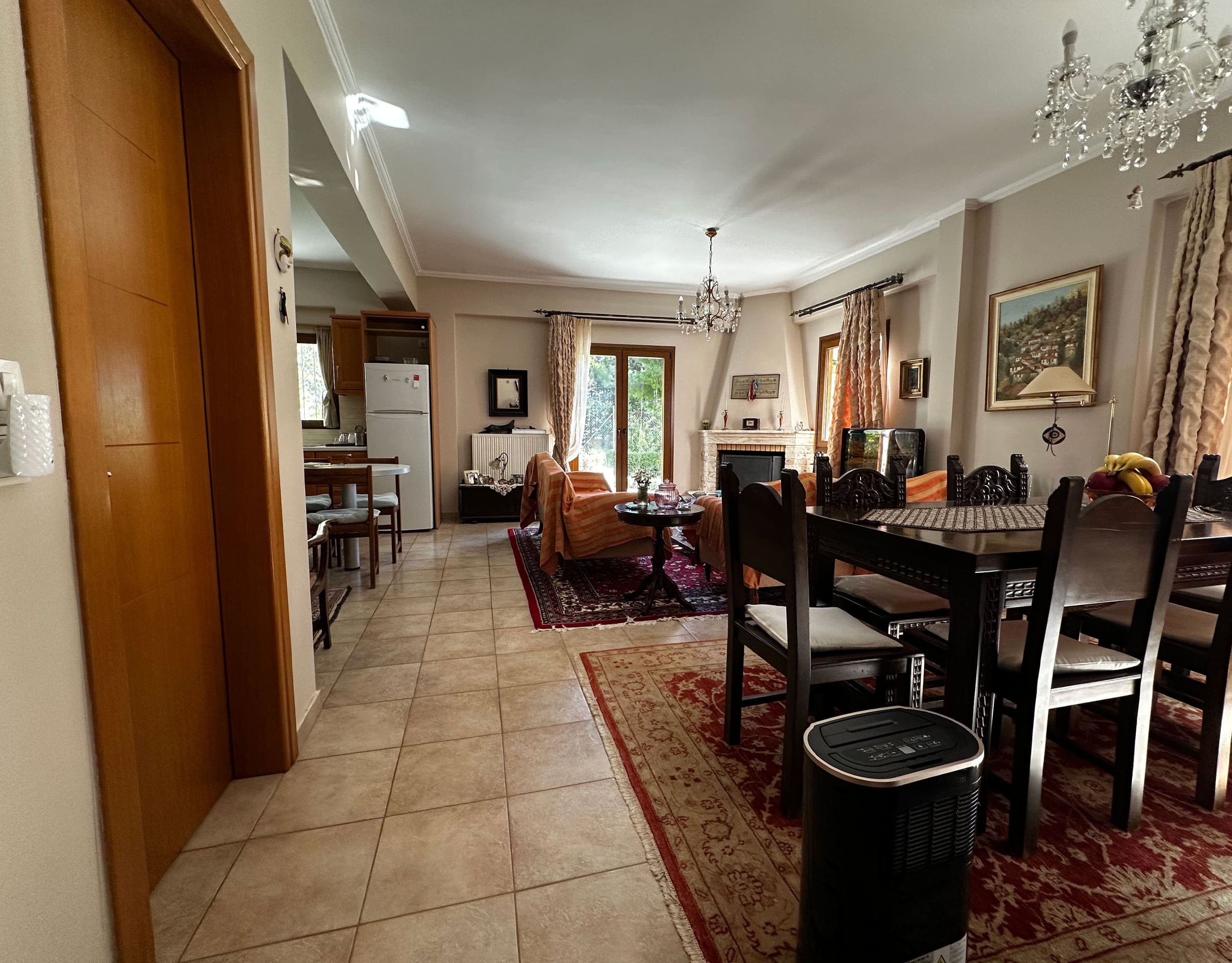 Open-plan dining and living area with tiled floor and classic furnishings, Thrakomakedones, Athens, Greece