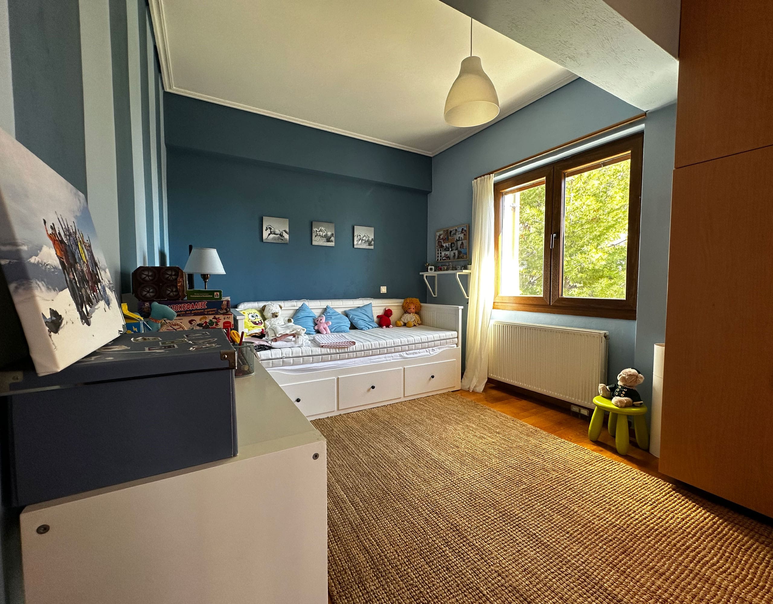 Children’s bedroom with blue walls, single beds, and wood flooring, Thrakomakedones, Athens, Greece