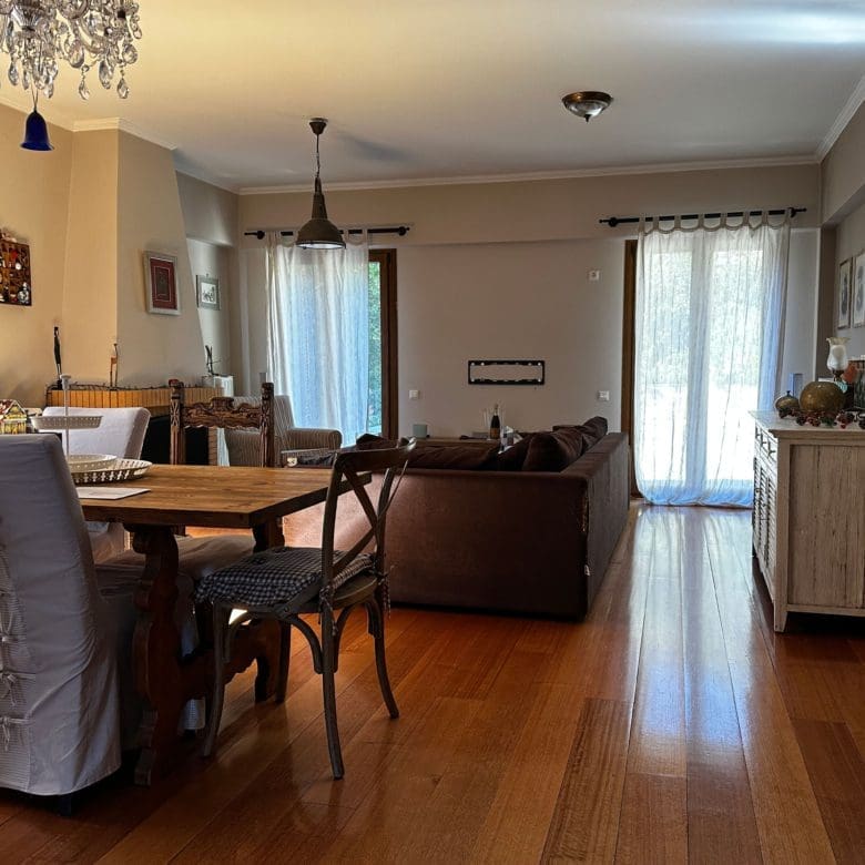 Dining area with chandelier, wood flooring, and living room connection, Thrakomakedones, Athens, Greece
