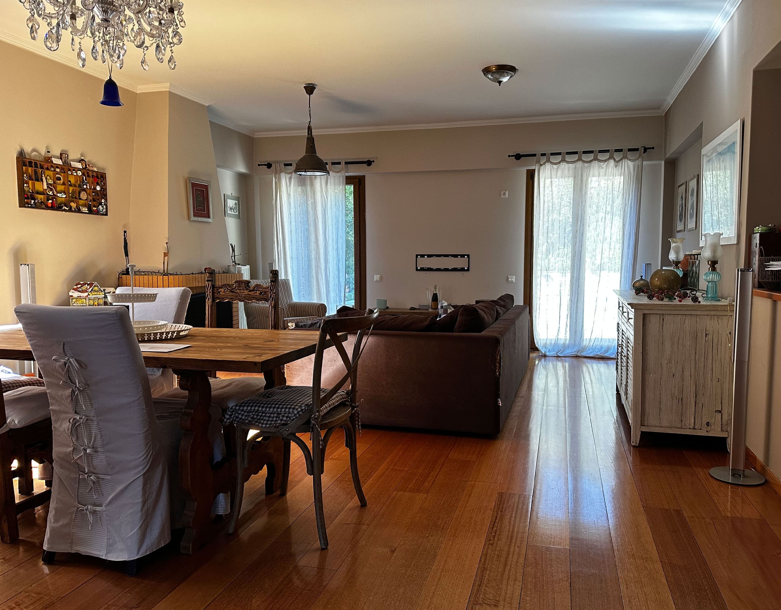 Dining area with chandelier, wood flooring, and living room connection, Thrakomakedones, Athens, Greece
