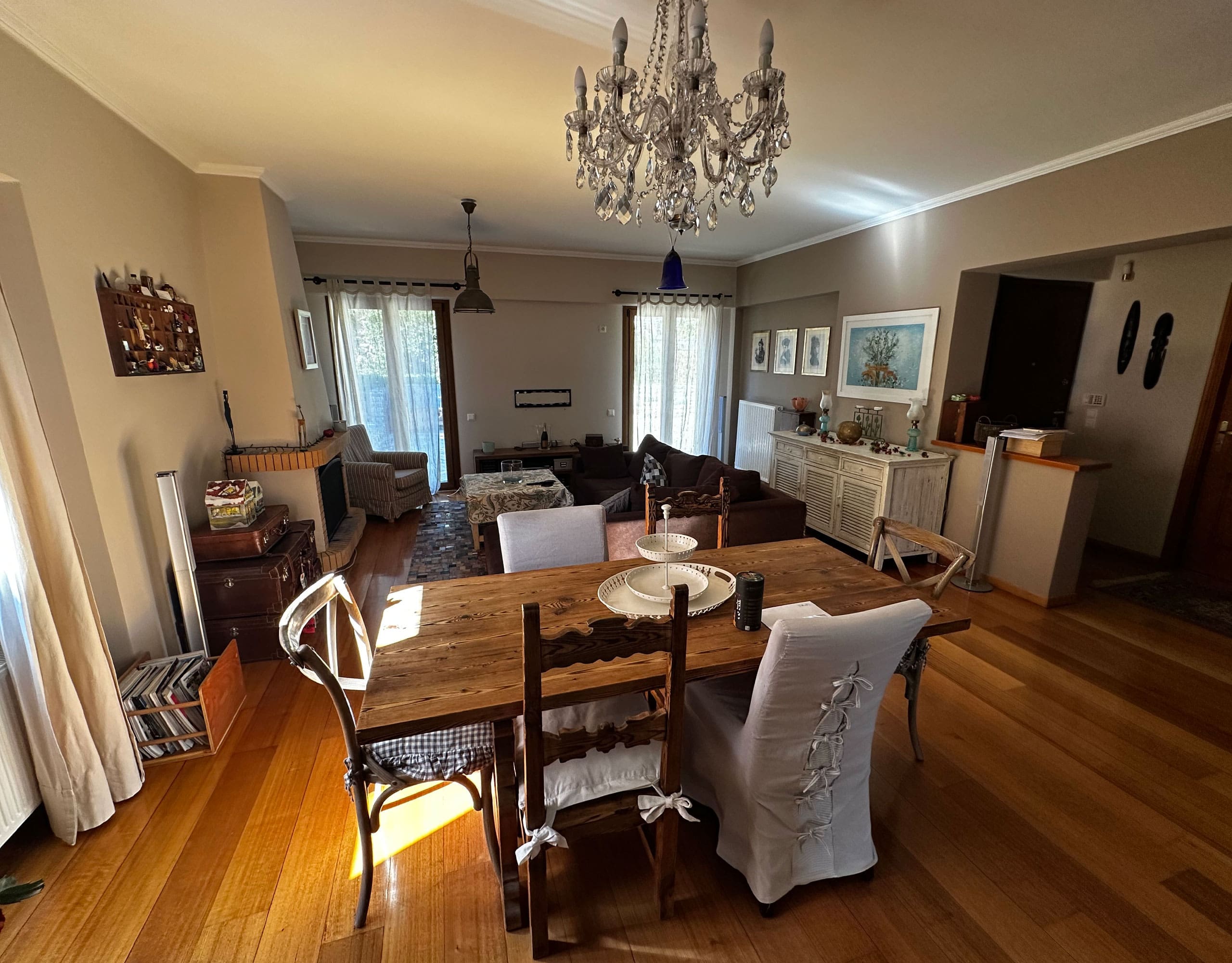 Dining area with chandelier, wood flooring, and open-plan layout, Thrakomakedones, Athens, Greece