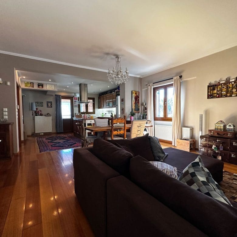 Living room with sofa seating and open-plan connection to the dining area, Thrakomakedones, Athens, Greece