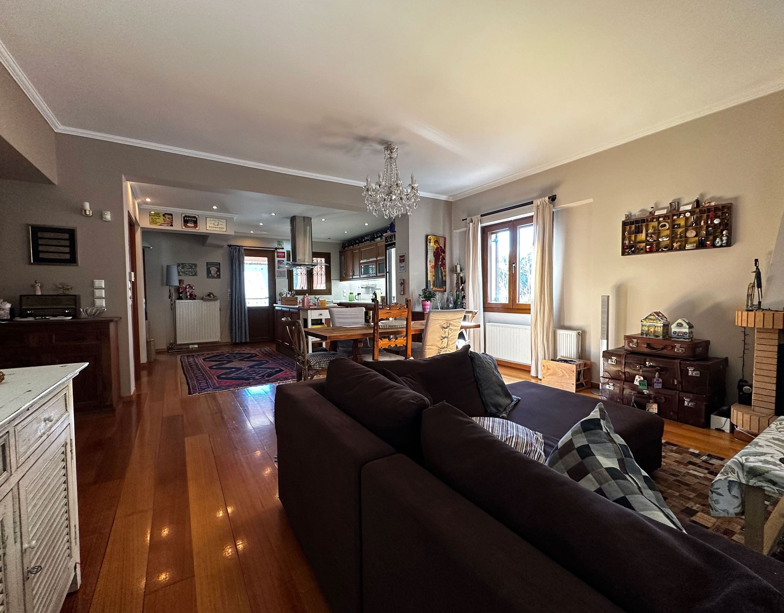 Living room with sofa seating and open-plan connection to the dining area, Thrakomakedones, Athens, Greece