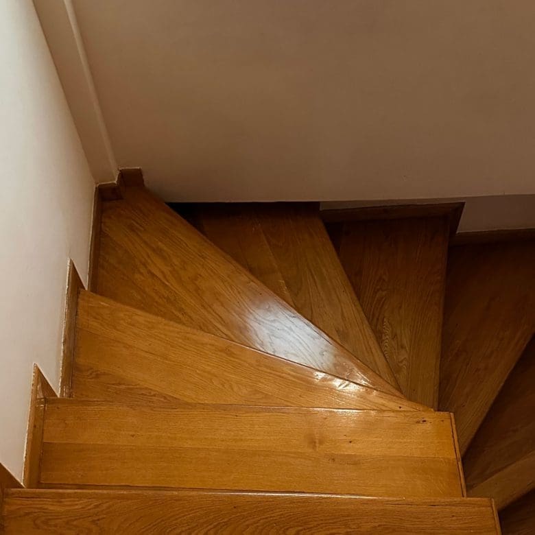 Wooden staircase detail with turning steps and white walls, Thrakomakedones, Athens, Greece