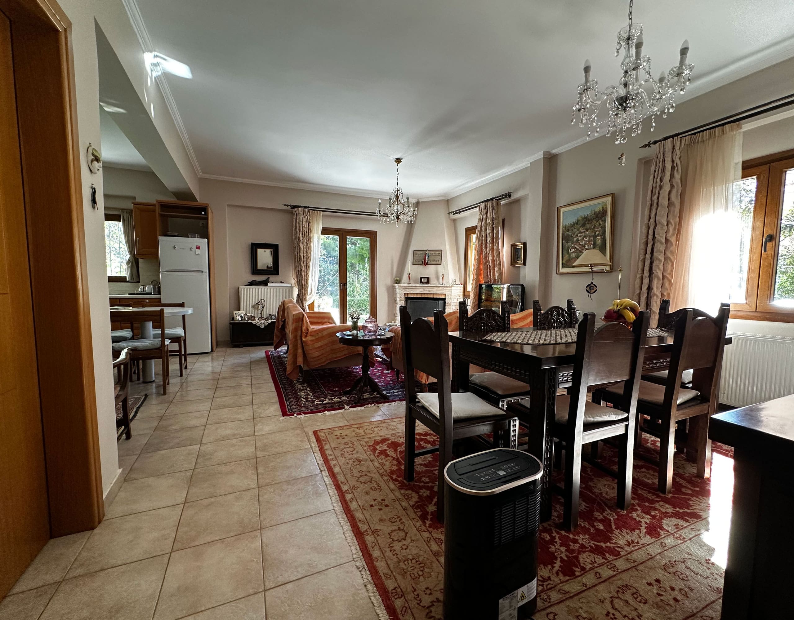 Open-plan dining and living area with chandelier and classic furnishings, Thrakomakedones, Athens, Greece