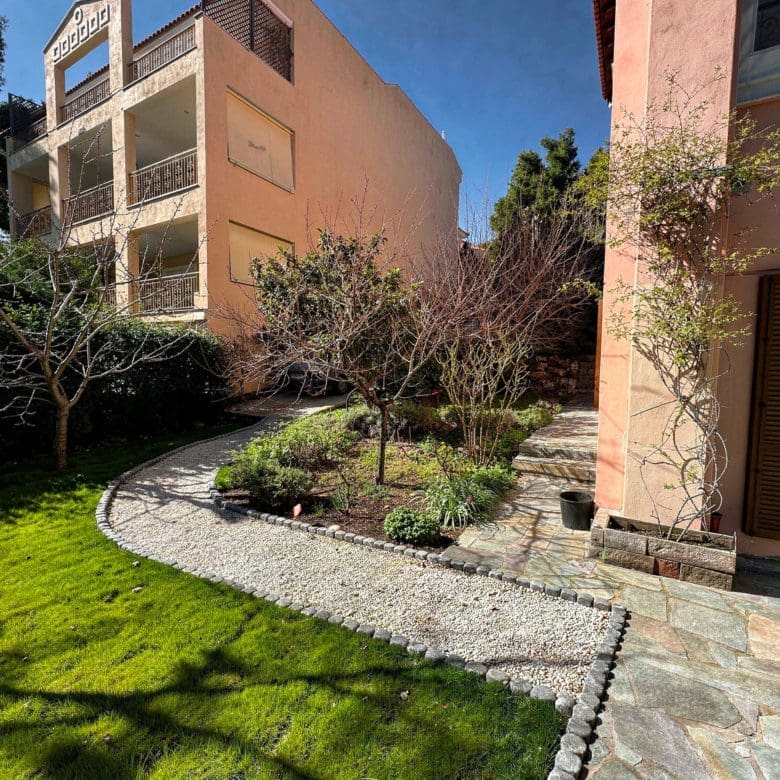 Garden view with lawn, curved stone path, and exterior facade, Thrakomakedones, Athens, Greece
