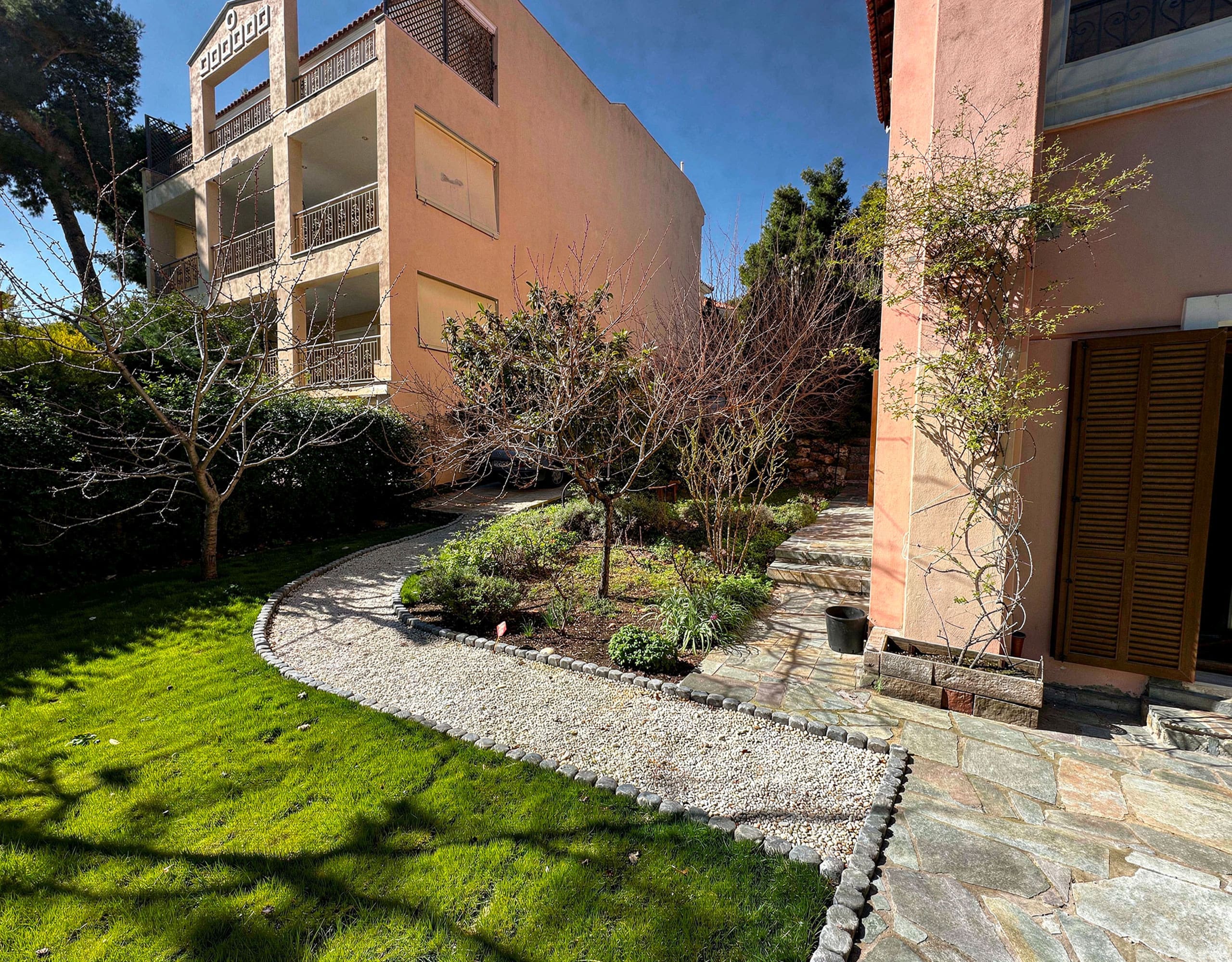 Garden view with lawn, curved stone path, and exterior facade, Thrakomakedones, Athens, Greece