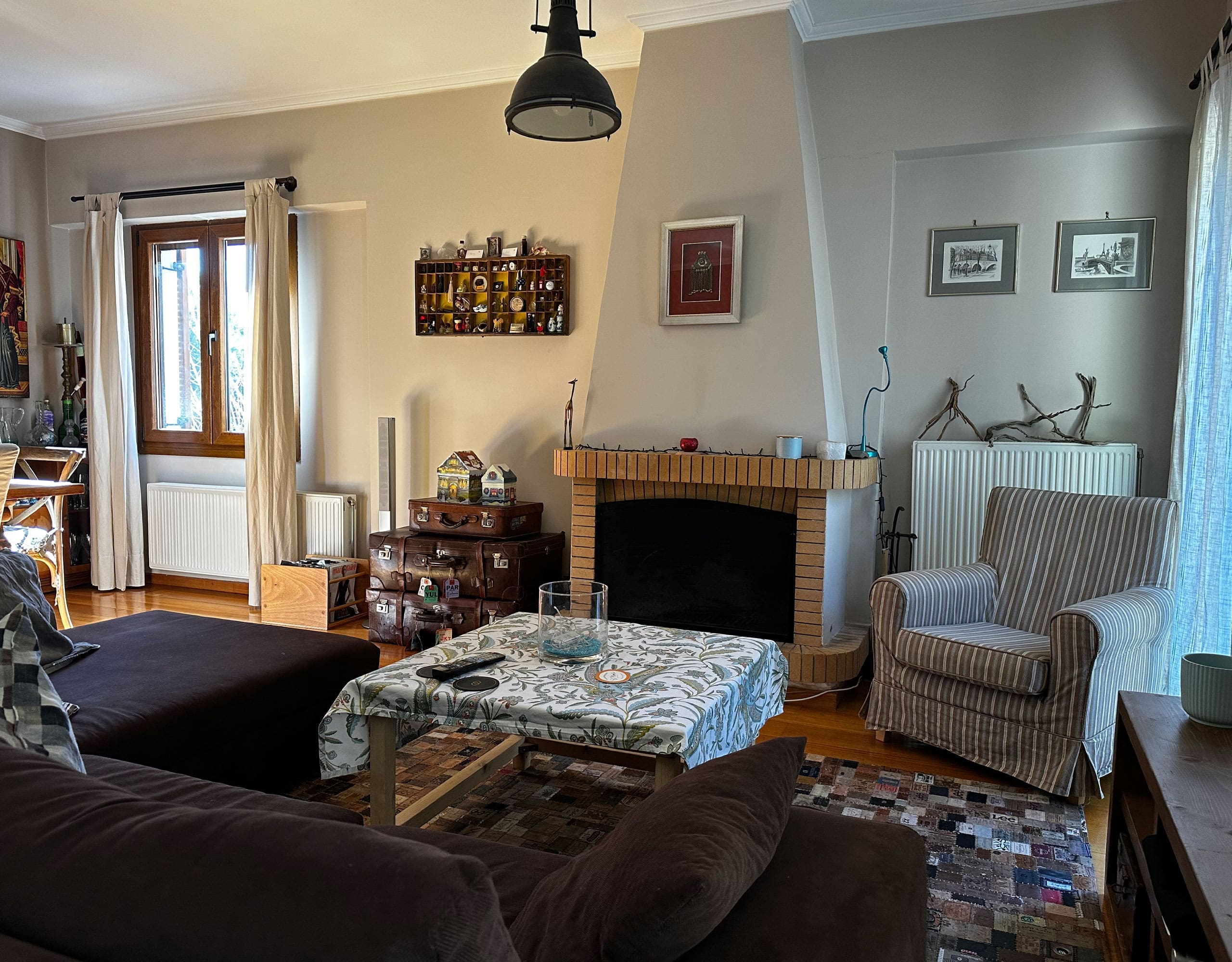 Living room with fireplace, seating area, and pendant light, Thrakomakedones, Athens, Greece