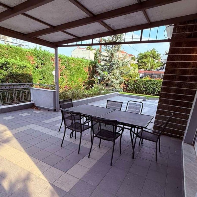 Covered balcony with outdoor dining table and garden views, Oreokastro, Thessaloniki, Greece