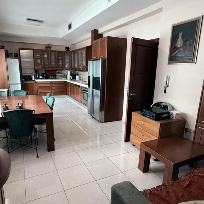 Open-plan kitchen and living area with tiled floor and built-in cabinetry, Oreokastro, Thessaloniki, Greece