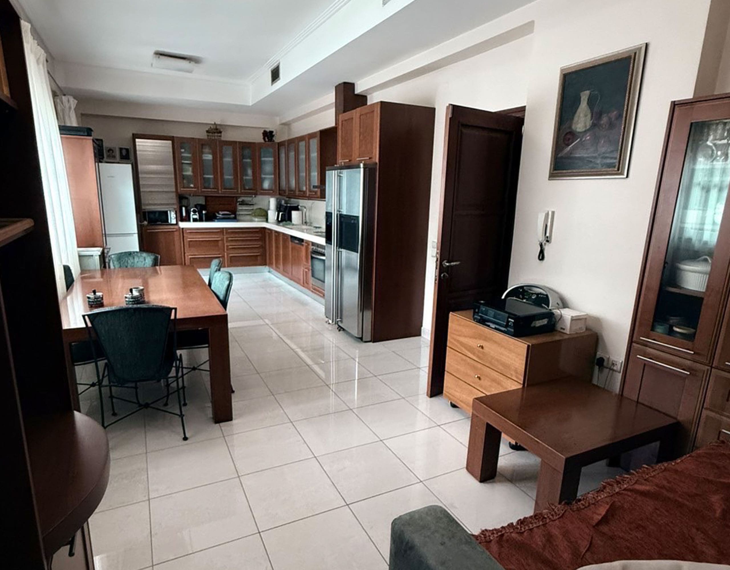 Open-plan kitchen and living area with tiled floor and built-in cabinetry, Oreokastro, Thessaloniki, Greece