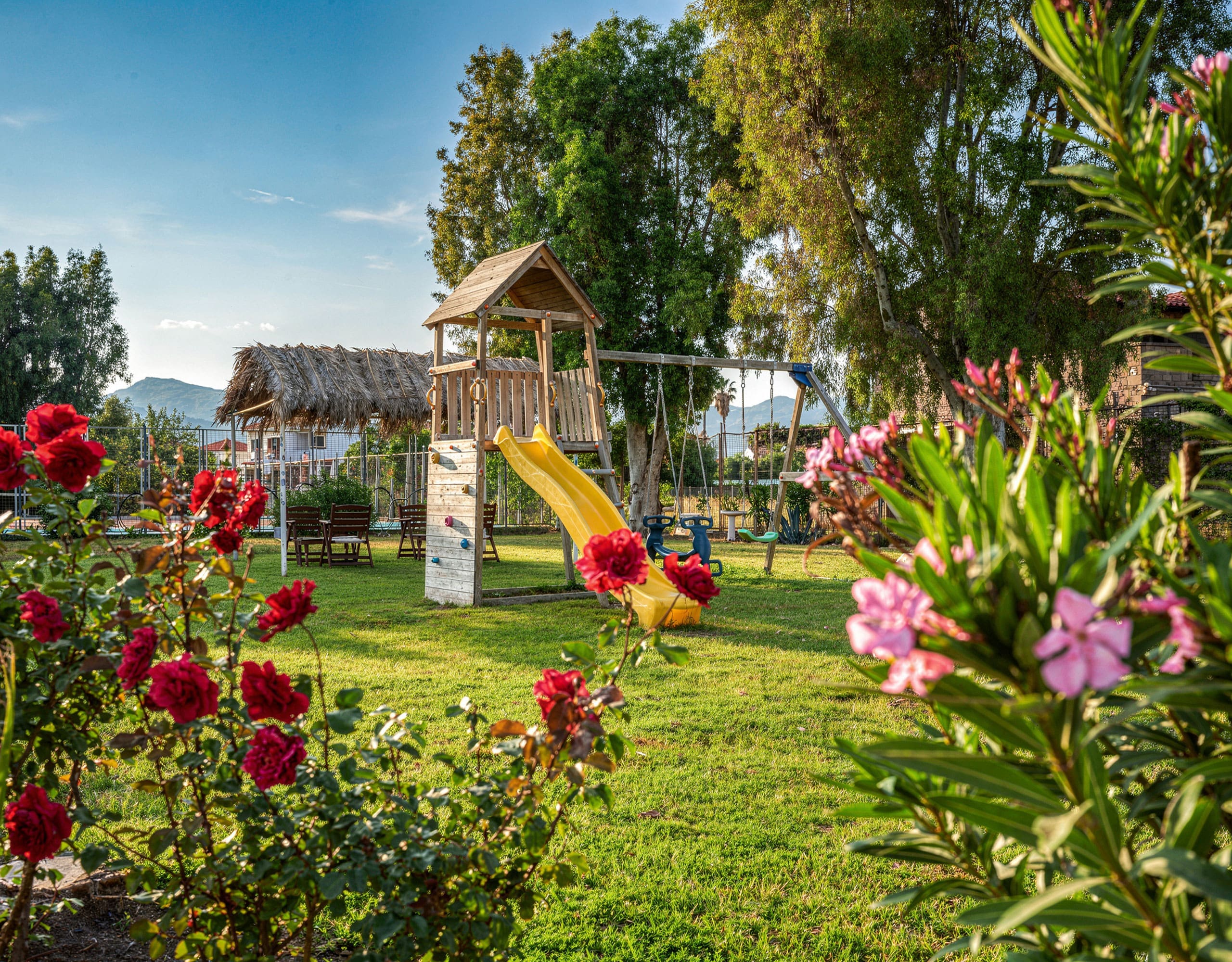 Skala Kallonis 3-Star Beachfront Hotel – Garden With Playground Landscaped garden with flowers and children’s playground, Skala Kallonis, Lesvos, Greece