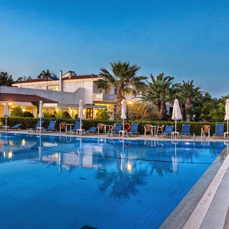 Evening view of the hotel swimming pool with lounge seating and lights, Skala Kallonis, Lesvos, Greece