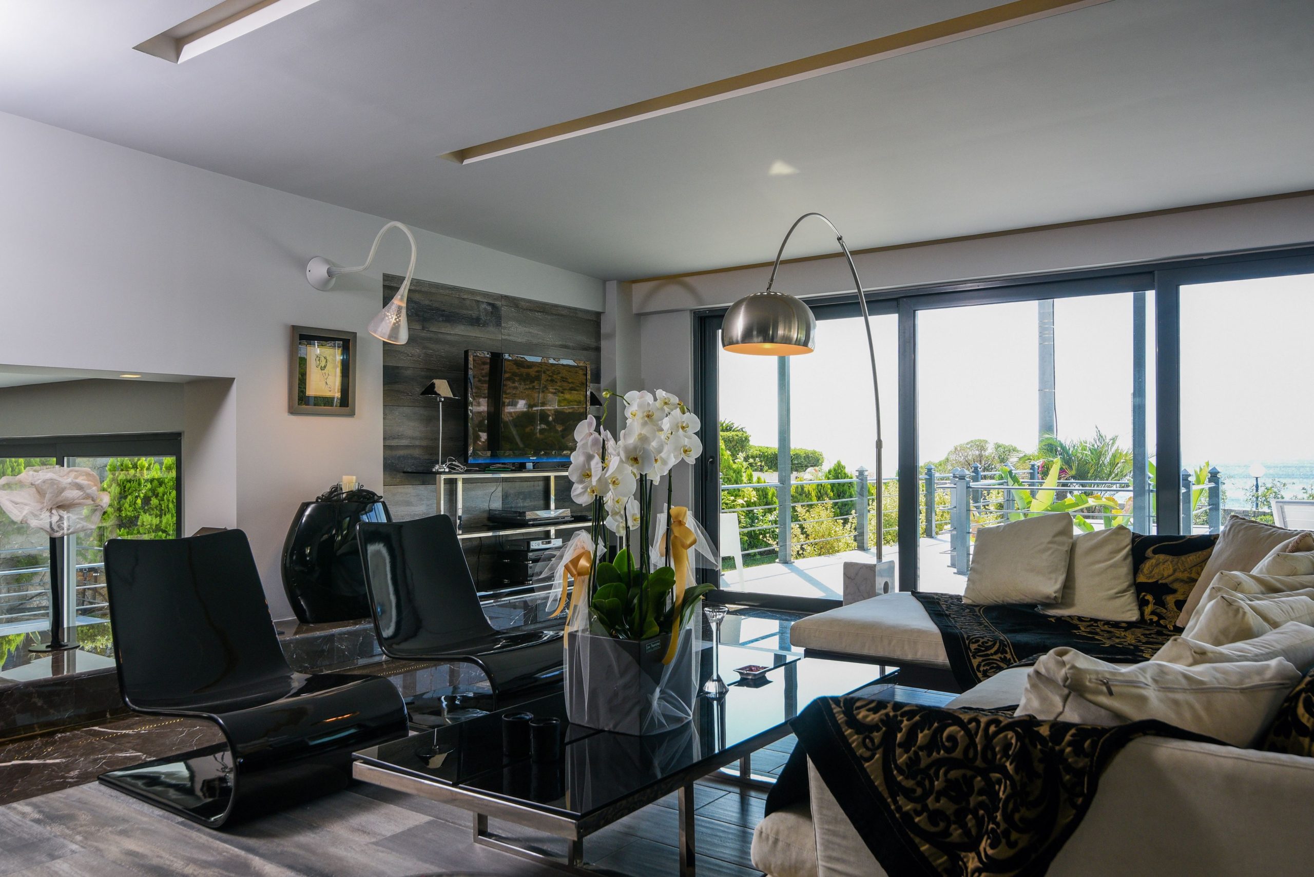 Sounio Beachfront Twin Villas – Living Room With Sliding Doors Modern living room with large sliding doors and indoor-outdoor seating, Sounio, Athens Riviera, Greece