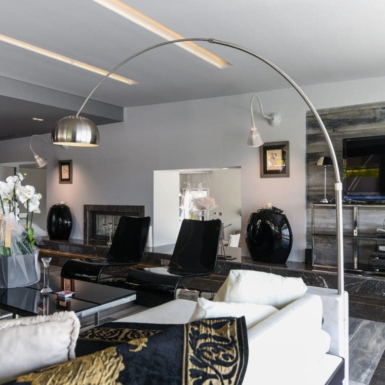 Open-plan lounge with curved ceiling lighting and modern seating, Sounio, Athens Riviera, Greece