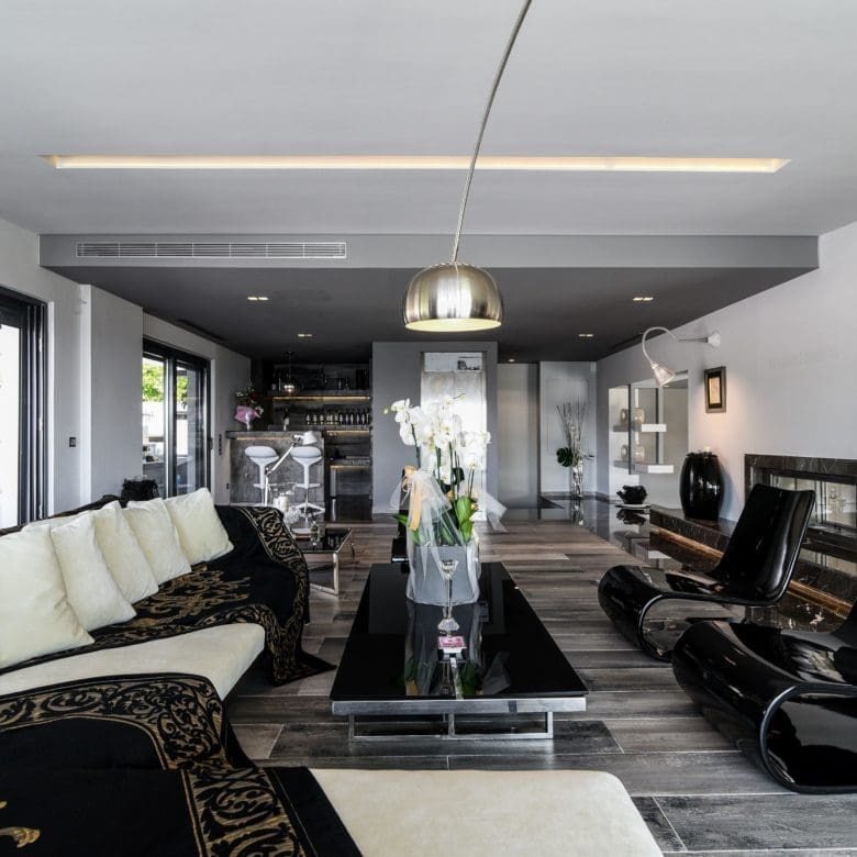 Spacious open-plan living area with modern sofas and large windows, Sounio, Athens Riviera, Greece