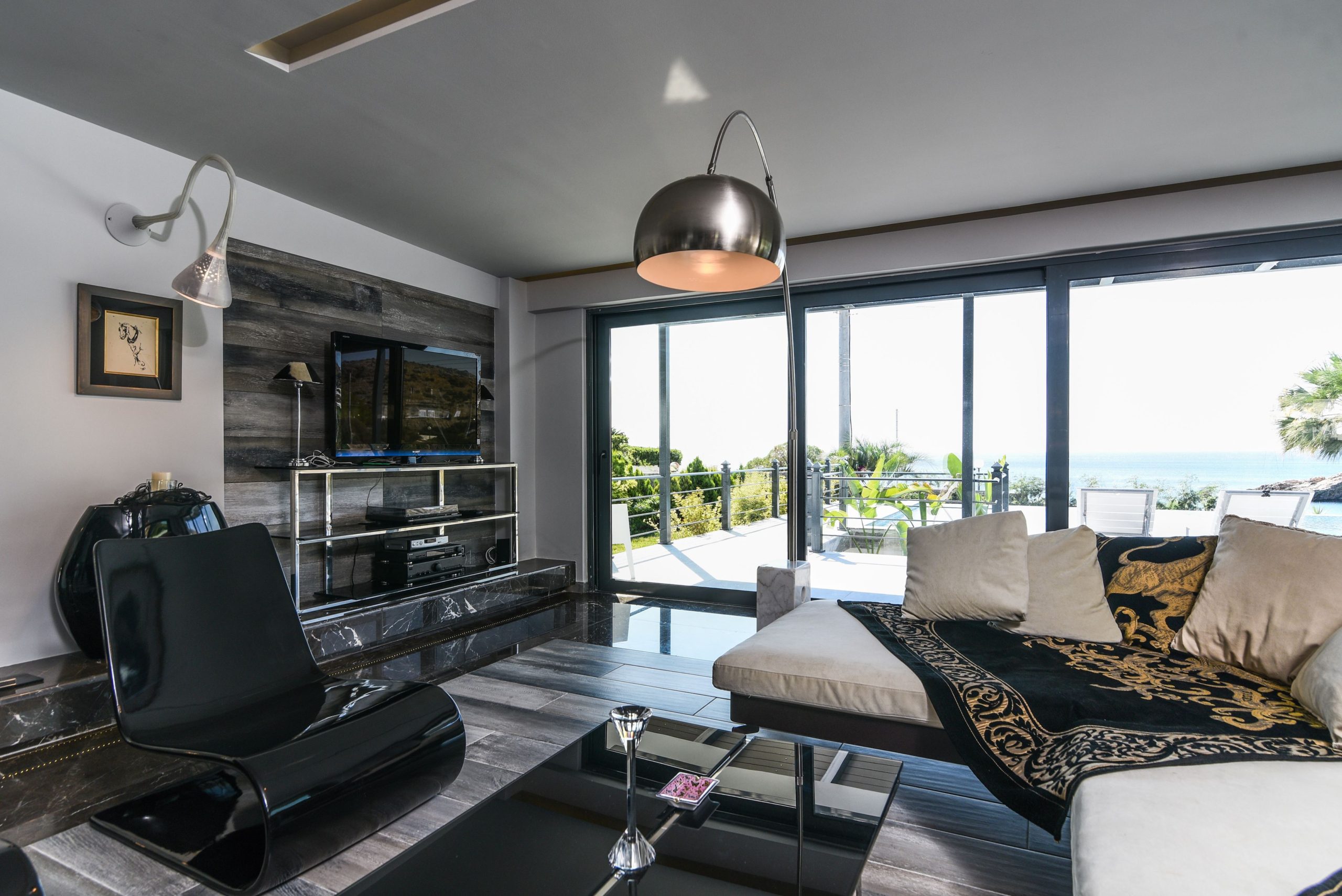 Sounio Beachfront Twin Villas – Living Area With Balcony Access Open-plan living room with seating area and large sliding doors to the balcony, Sounio, Athens Riviera, Greece