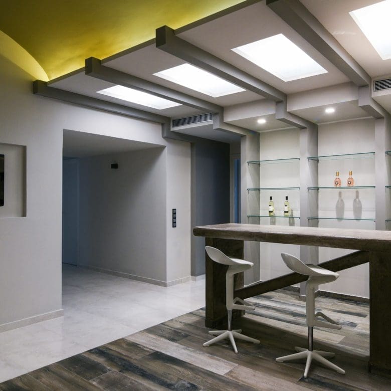 Modern bar area with ceiling lighting and built-in shelving, Sounio, Athens Riviera, Greece