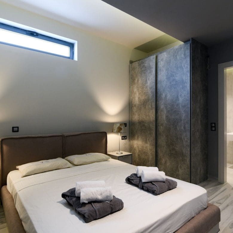Modern bedroom with double bed, accent wall, and soft ambient lighting, Sounio, Athens Riviera, Greece