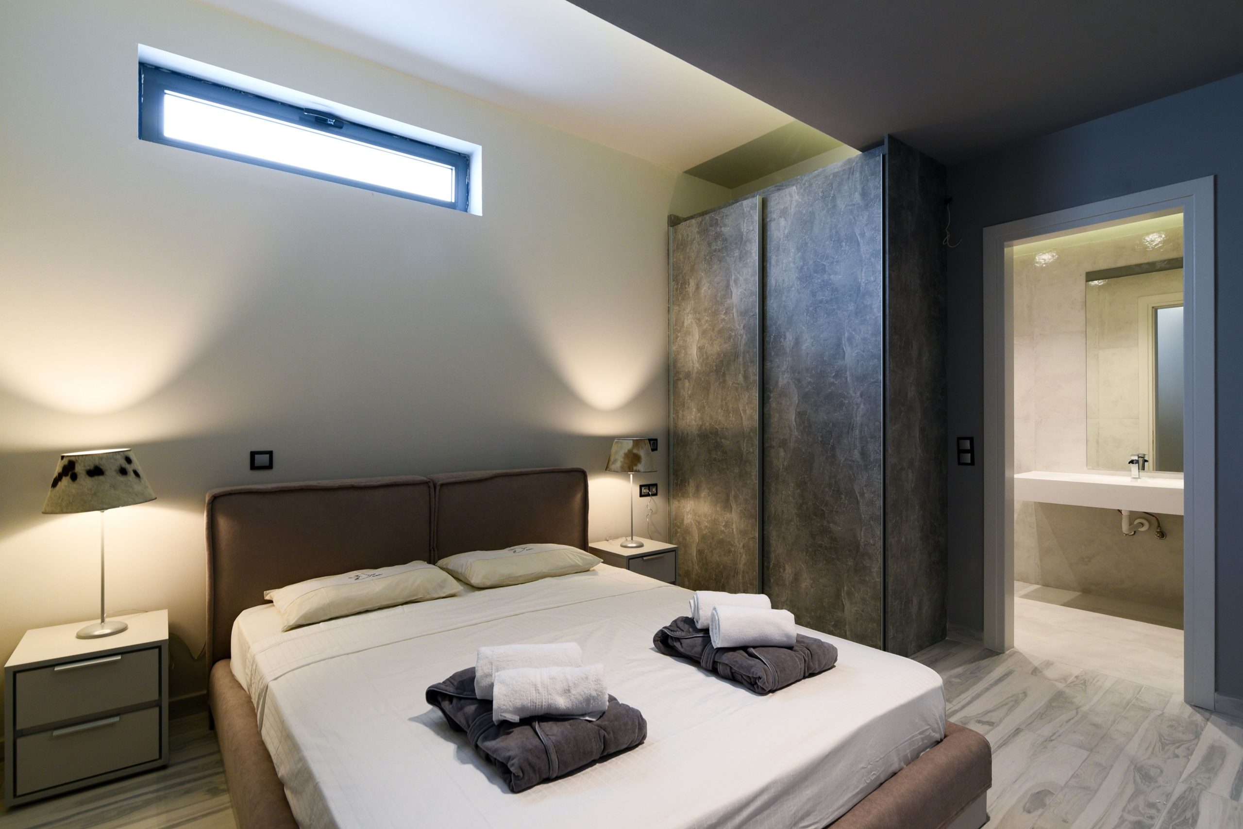 Sounio Beachfront Twin Villas – Bedroom With Ambient Lighting Modern bedroom with double bed, accent wall, and soft ambient lighting, Sounio, Athens Riviera, Greece