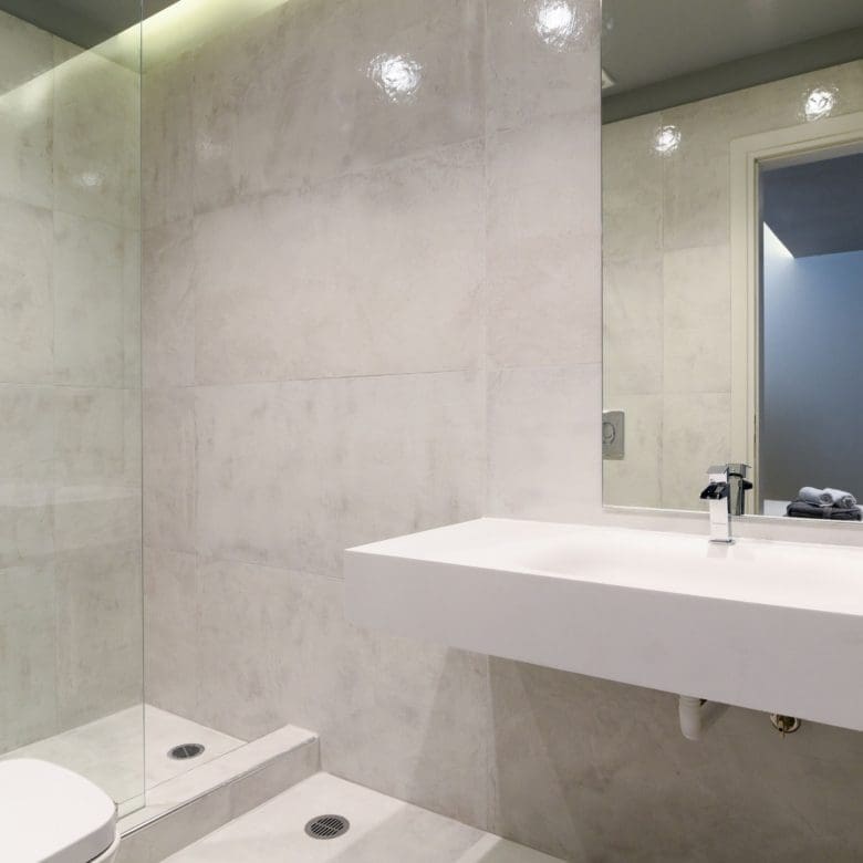 Minimal bathroom with walk-in shower, white vanity, and clean stone-look finishes, Sounio, Athens Riviera, Greece
