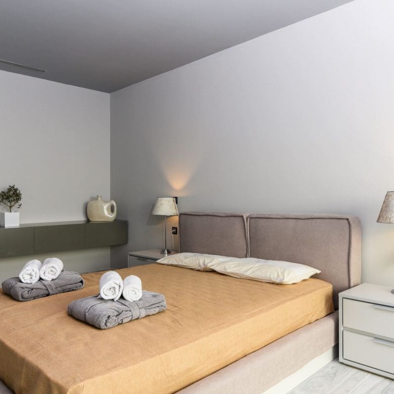 Modern bedroom with double bed, bedside tables, and neutral tones, Sounio, Athens Riviera, Greece