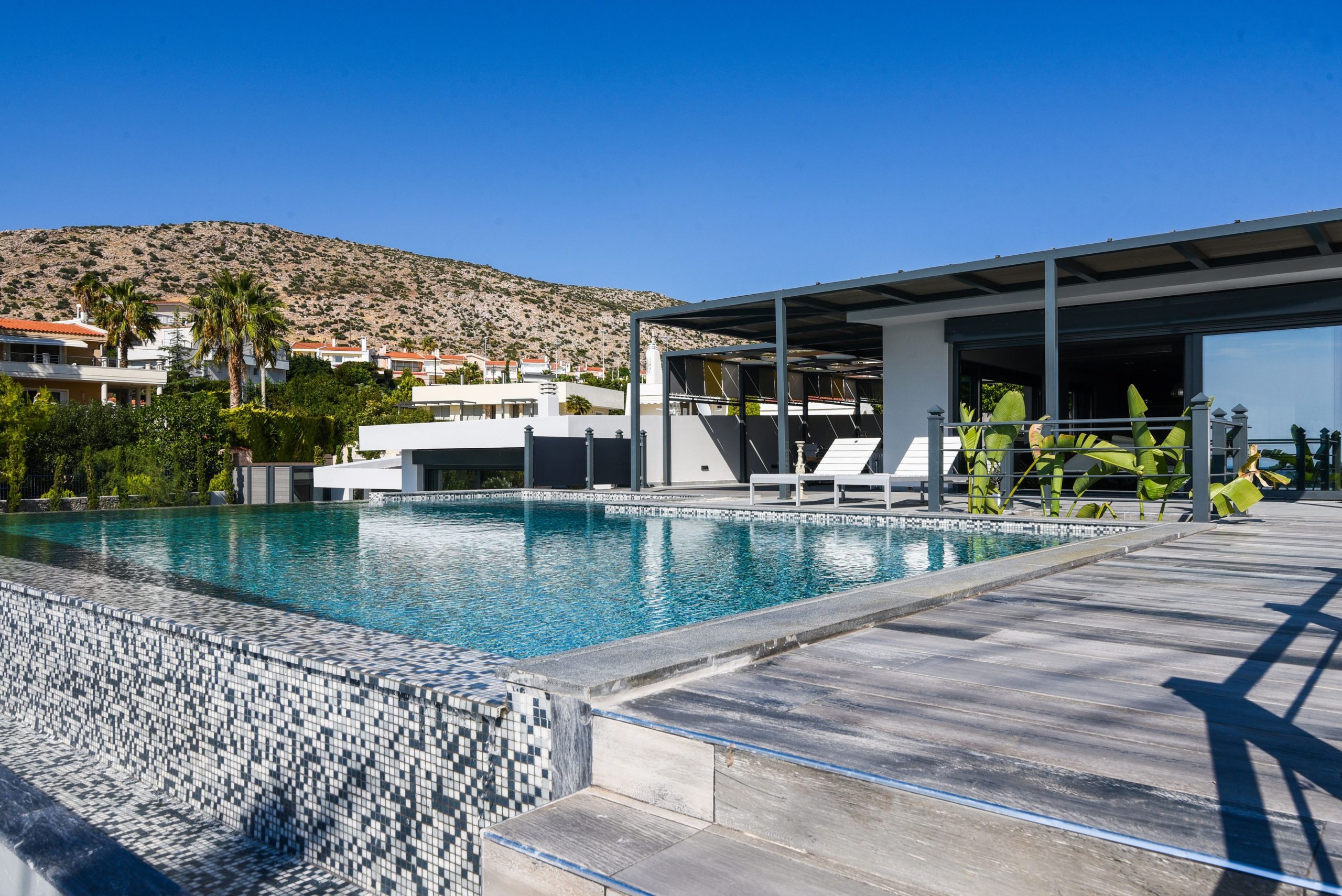 Sounio Beachfront Twin Villas – Infinity Pool And Exterior Infinity pool with mosaic tile edge and modern villa exterior, Sounio, Athens Riviera, Greece