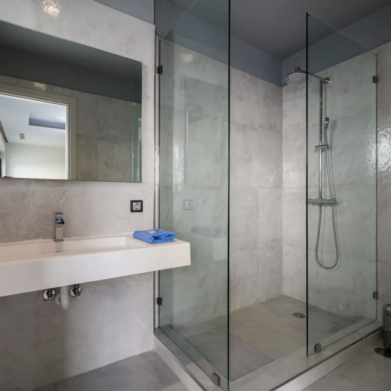 Bathroom detail with vanity, mirror, and glass shower enclosure, Sounio, Athens Riviera, Greece
