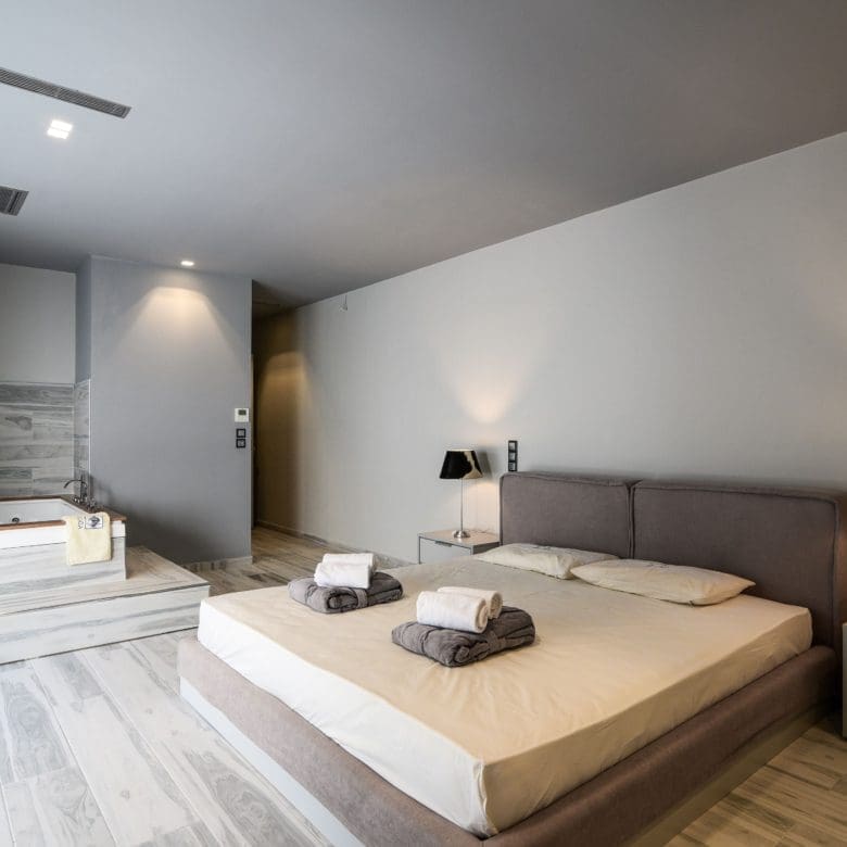 Spacious bedroom with double bed and open-plan layout, Sounio, Athens Riviera, Greece