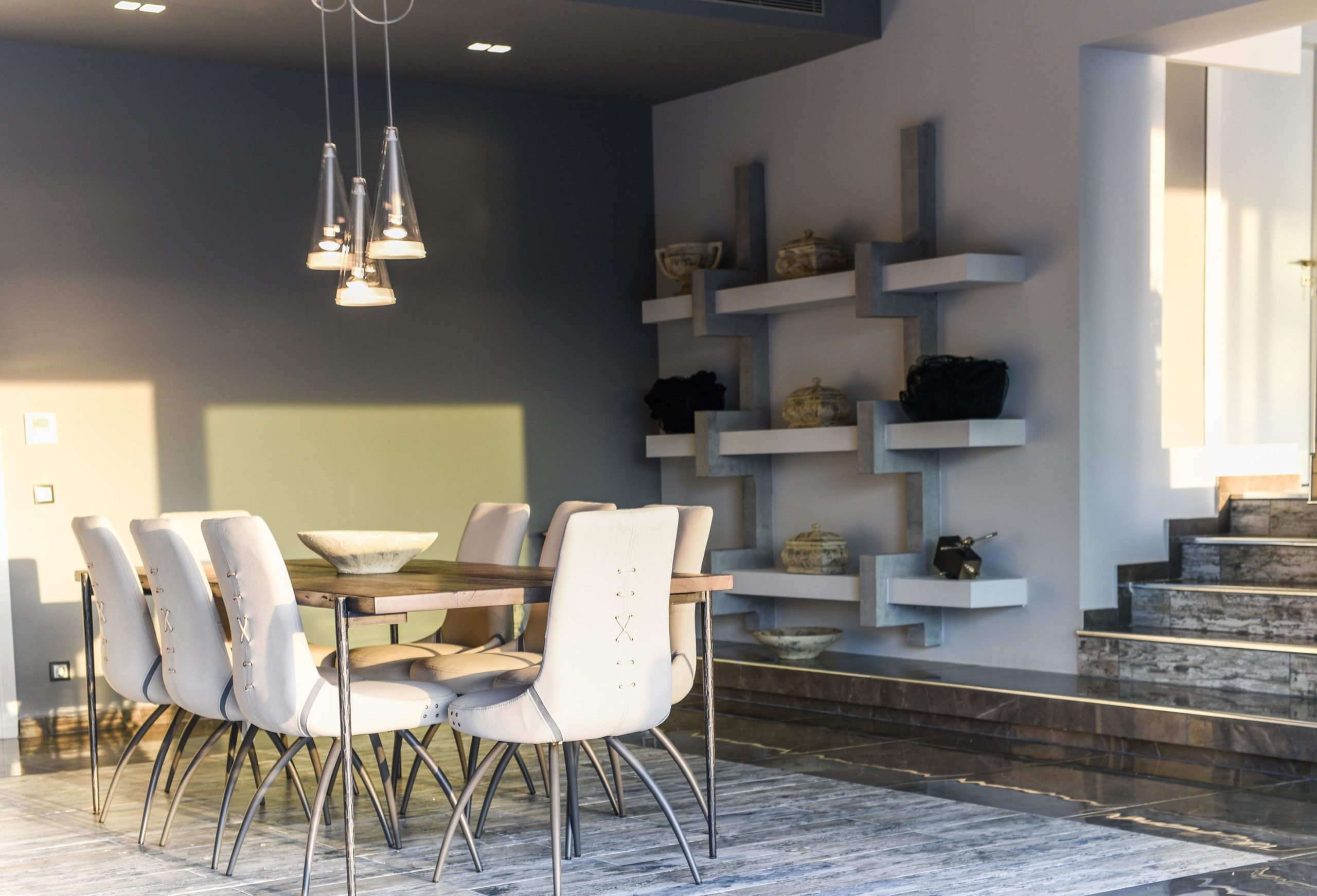 Sounio Beachfront Twin Villas – Dining Area With White Chairs Dining area with white chairs, pendant light, and open-plan living connection, Sounio, Athens Riviera, Greece