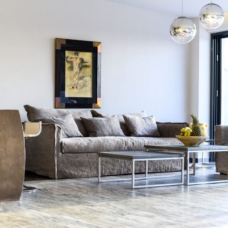 Modern living room with sectional sofa and large window opening to the terrace, Sounio, Athens Riviera, Greece
