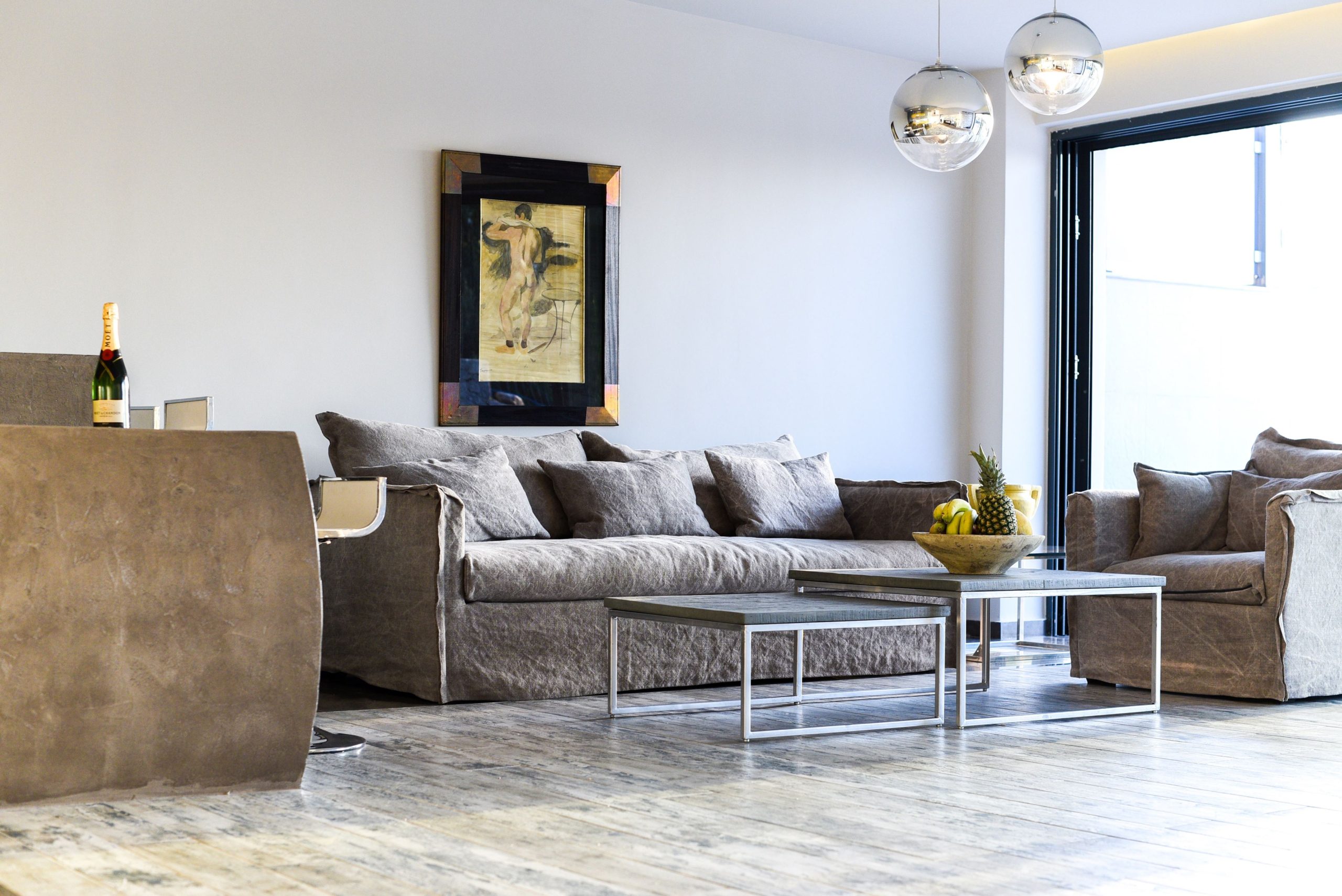 Sounio Beachfront Twin Villas – Living Room With Terrace Access Modern living room with sectional sofa and large window opening to the terrace, Sounio, Athens Riviera, Greece