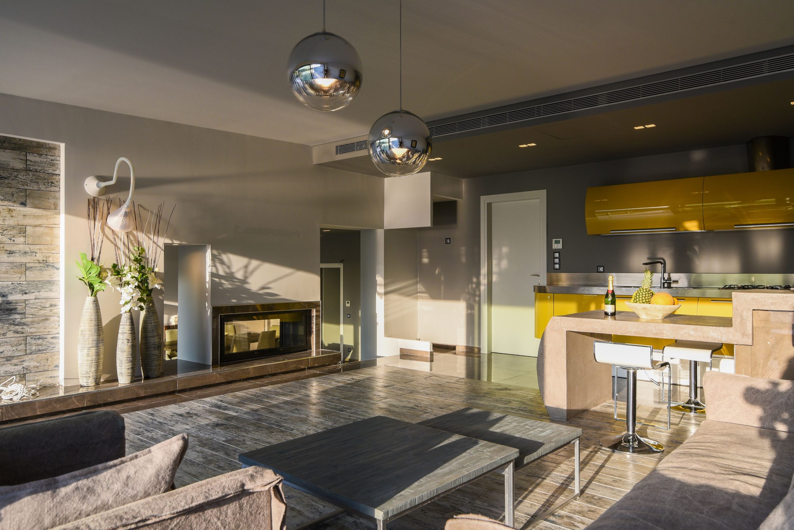 Sounio Beachfront Twin Villas – Open-Plan Living And Kitchen (Evening View) Open-plan living room and kitchen with island, pendant lights, and evening ambiance, Sounio, Athens Riviera, Greece