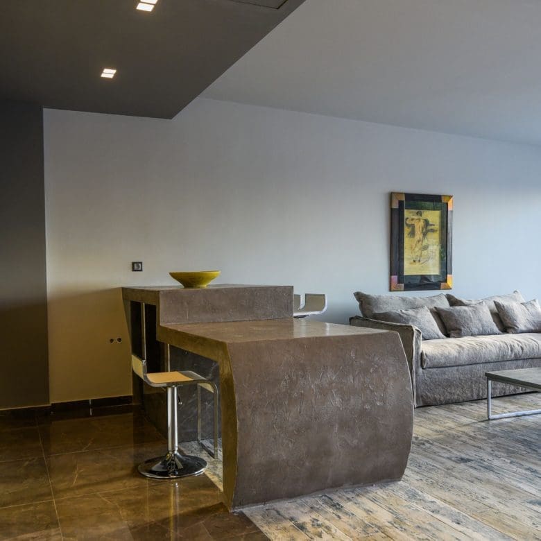 Open-plan living room and kitchen with island seating and modern finishes, Sounio, Athens Riviera, Greece