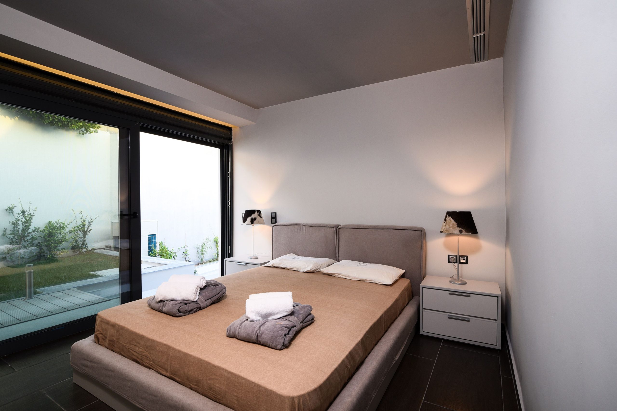 Sounio Beachfront Twin Villas – Bedroom With Terrace Access Modern bedroom with double bed and large sliding doors to the terrace, Sounio, Athens Riviera, Greece