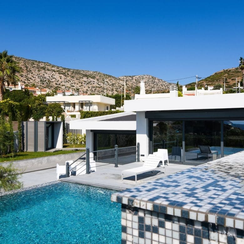 Infinity pool corner with mosaic tiles and modern outdoor lounge area, Sounio, Athens Riviera, Greece