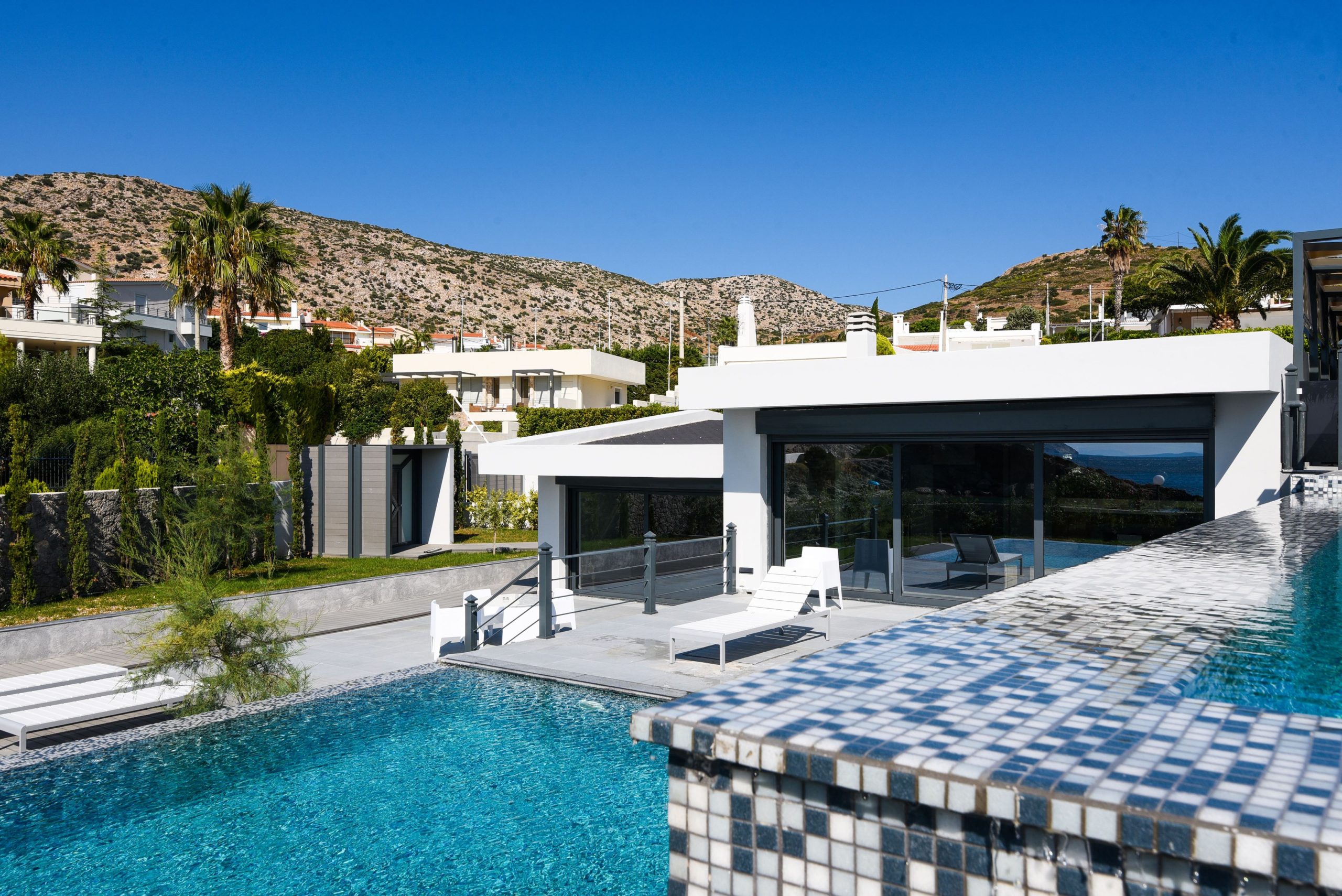 Sounio Beachfront Twin Villas – Pool Corner And Outdoor Lounge Infinity pool corner with mosaic tiles and modern outdoor lounge area, Sounio, Athens Riviera, Greece