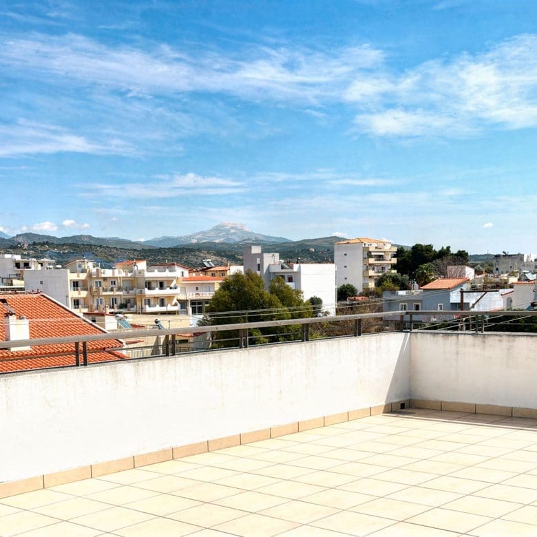 Large terrace with tiled floor and open views over rooftops, Vasiliko, Evia, Greece