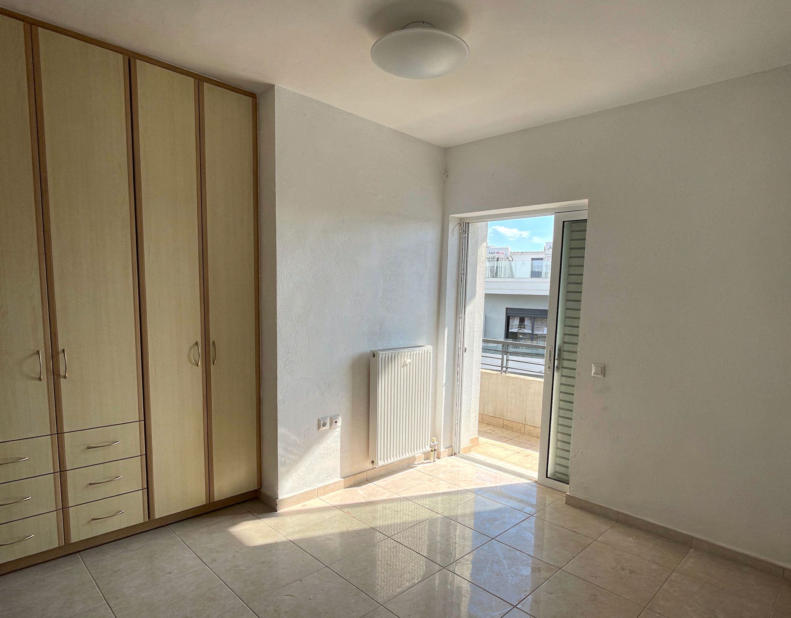 Bedroom with built-in wardrobes and balcony door, Vasiliko, Evia, Greece